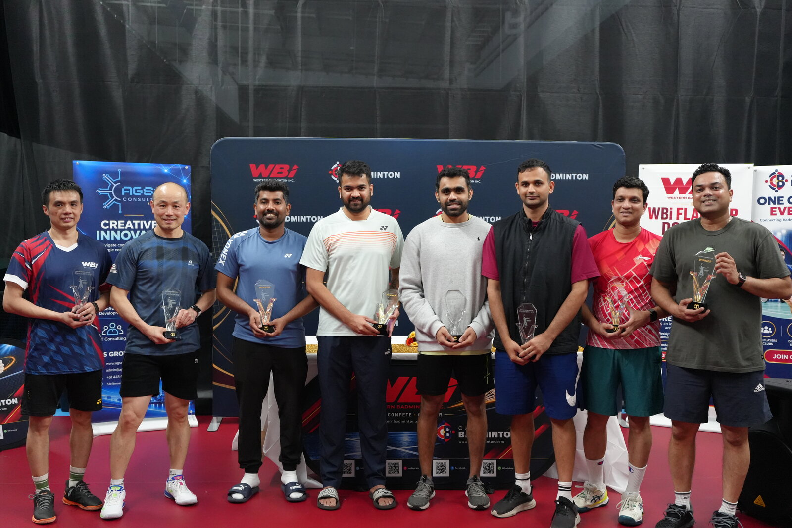 WBi 2026 men's doubles winners and runners-up celebrating with their trophies