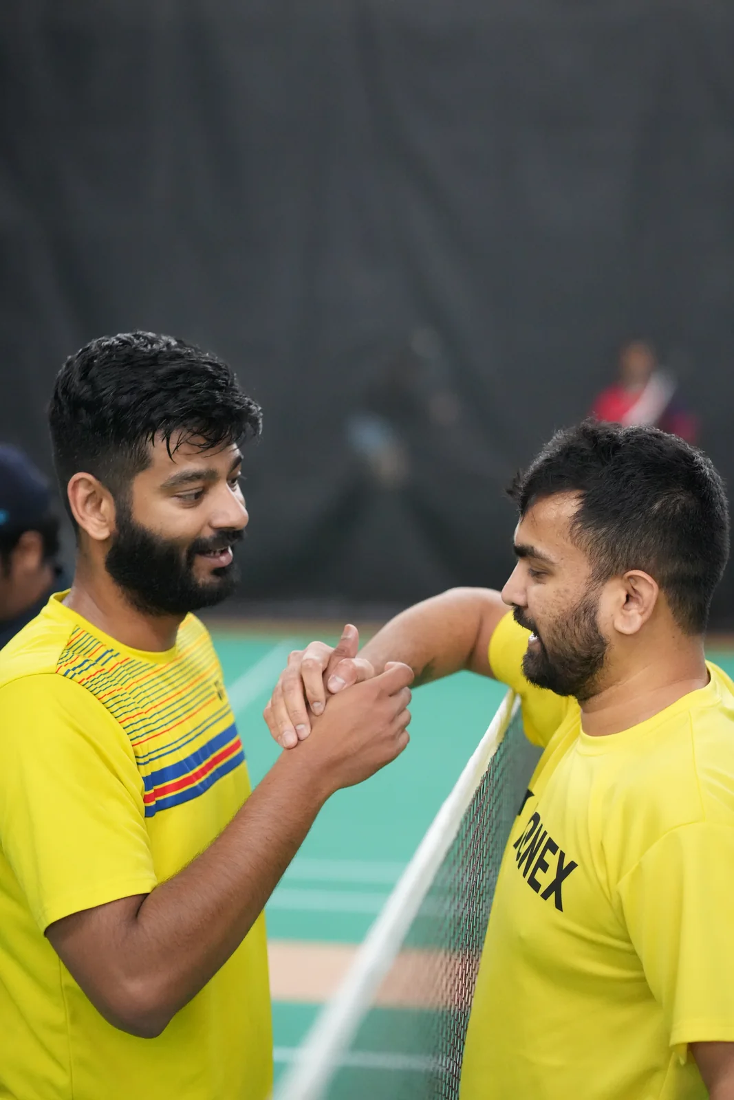 Two teammates sharing a smile courtside